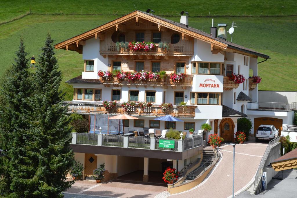 a large building with balconies and flowers on it at Landhaus Montana in Gerlos