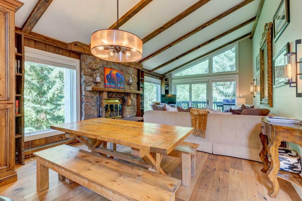 a living room with a wooden table and a couch at Mountain-View Vail Condo with Balcony and Gas Grill! in Vail