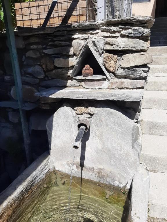 a bird bath with a water fountain at La Maison Trésallet in La Plagne Tarentaise