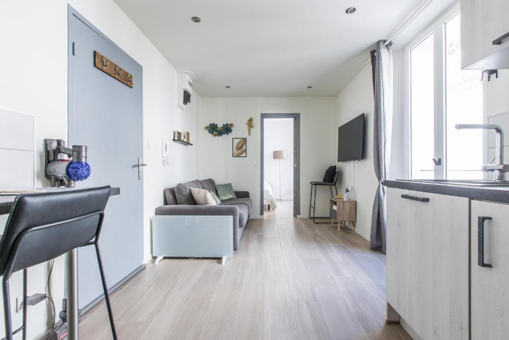a kitchen and living room with a couch at Cute Affordable 1-Br Minutes From Cannes Center in Cannes
