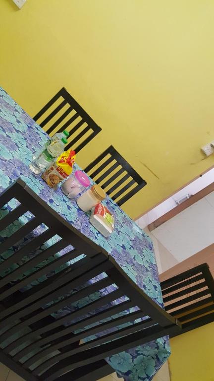a bed in a room with a table with food on it at SRHOMESTAY KUALA TERENGGANU in Kuala Terengganu