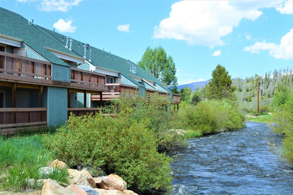 a river in front of a lodge with at Twin Rivers By Alderwood Colorado Management in Fraser