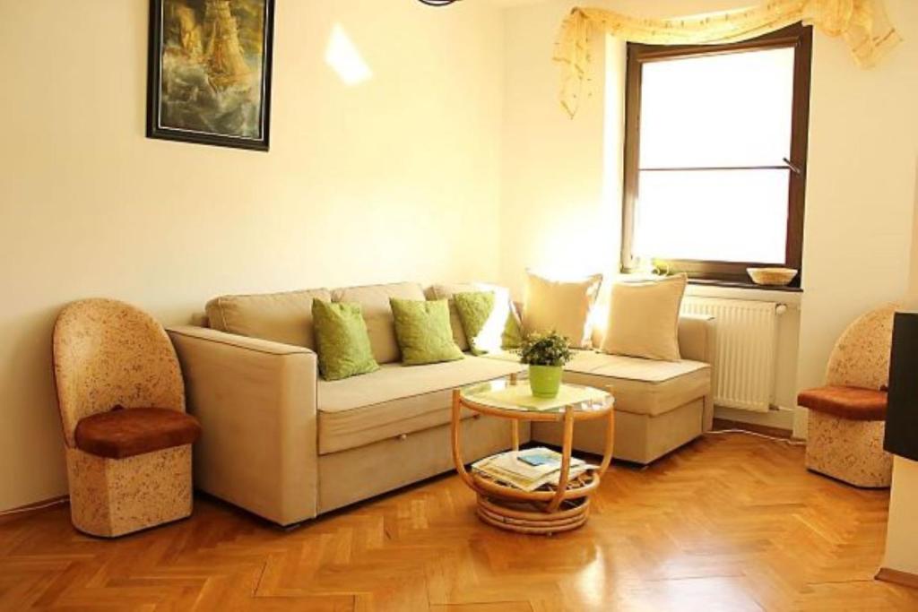 a living room with a couch and a table at Apartament Teresa in Łeba