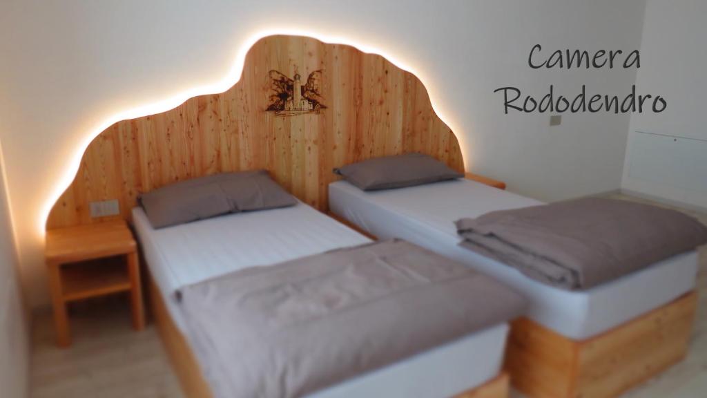 Postel nebo postele na pokoji v ubytování B&B A piè Paganella