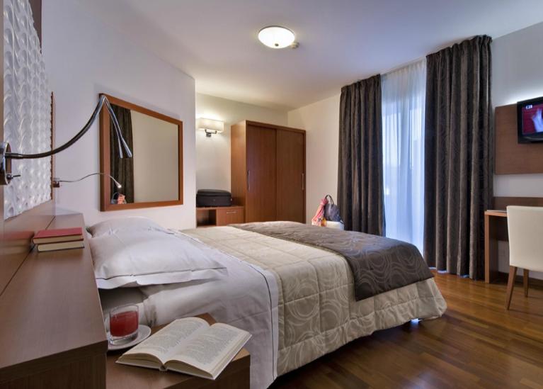 Posteľ alebo postele v izbe v ubytovaní Hotel Lo Zodiaco