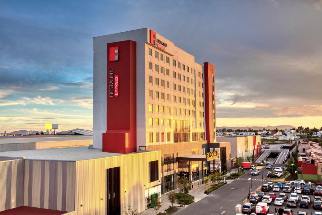 a rendering of a building with a parking lot at Fiesta Inn Express Puebla Explanada in Puebla