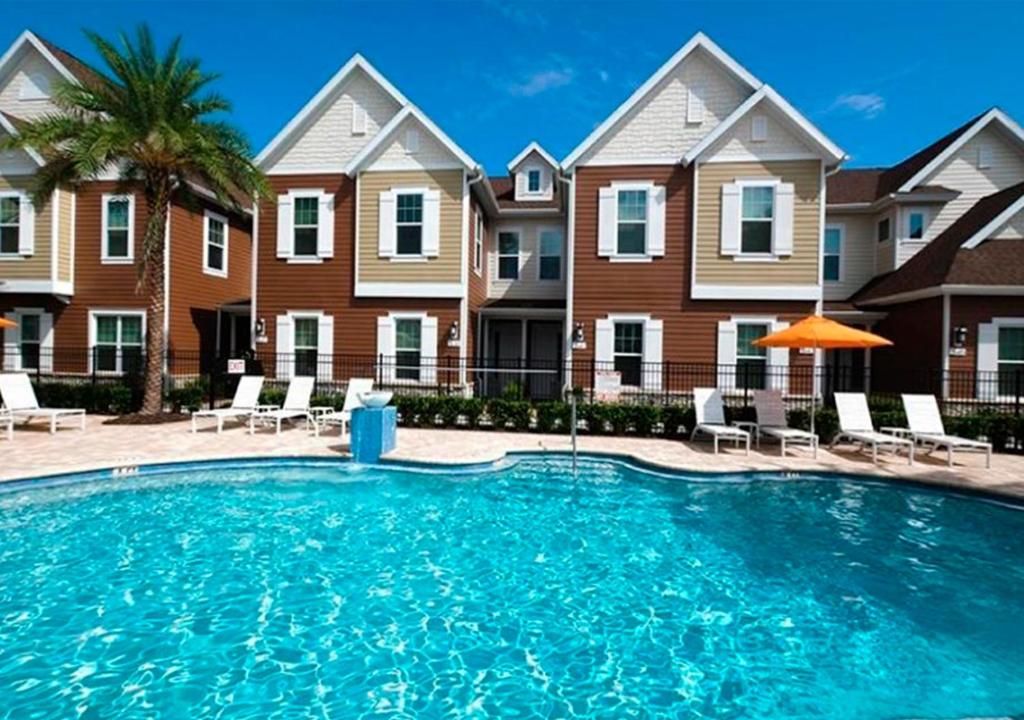 a large swimming pool in front of some houses at Casa Na Disney/ Summerville Resort in Orlando