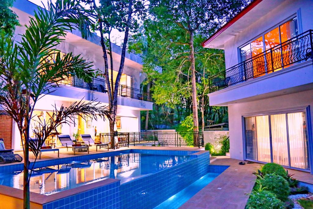 a house with a swimming pool in front of a house at Koh Chang 6 Bedroom Villa with Private Pool and Garden in Ko Chang