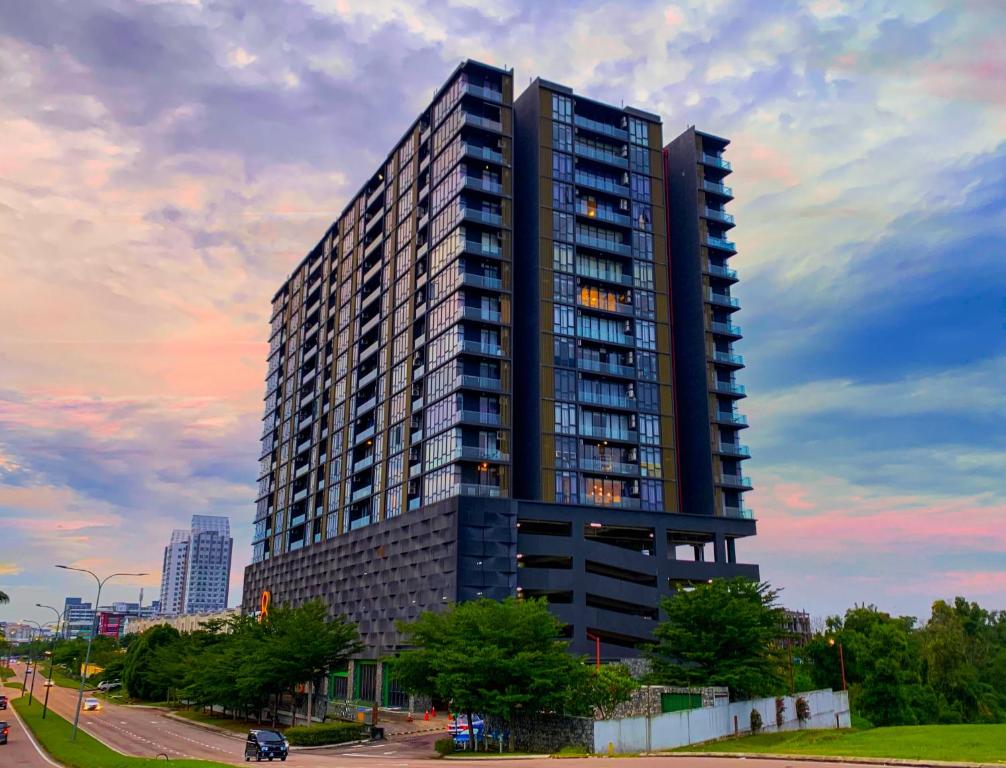 a tall black building with a sunset in the background at Cube 8teens by Nest Home in Johor Bahru