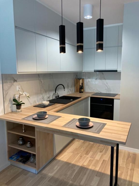 a kitchen with a counter with two bowls on it at Apartament Wiosenna in Białystok