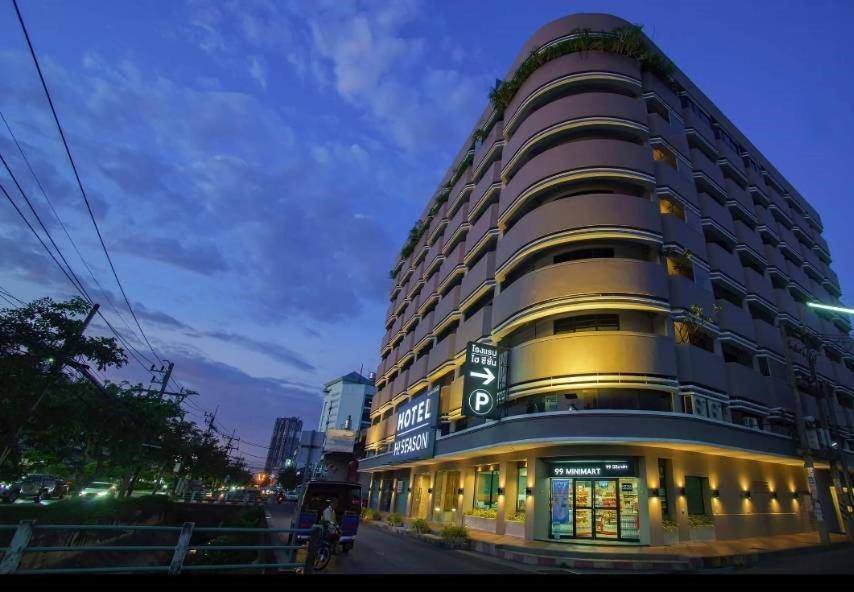 a large building on the side of a street at Hi Season Hotel in Hat Yai