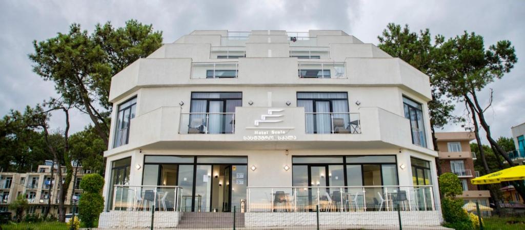 a white house with a round roof at Hotel Scala in Shekhvetili