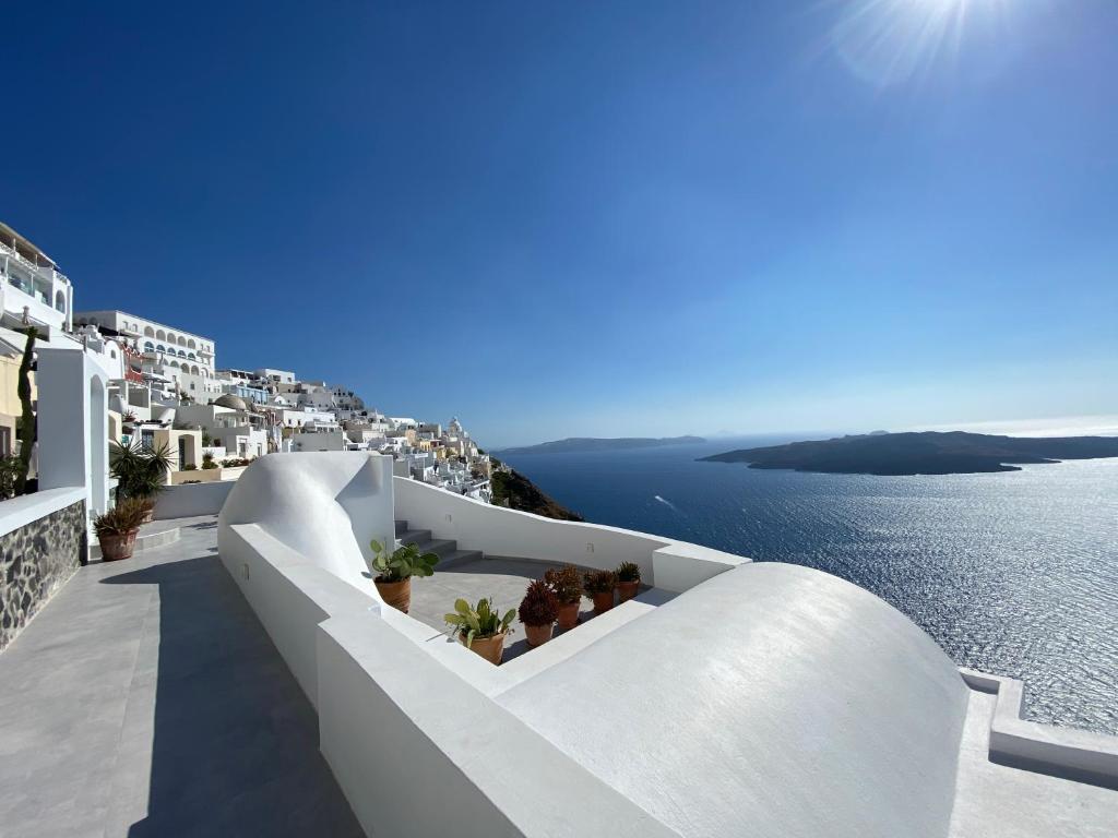a view of the ocean from the balcony of a villa at Panorama Suites in Fira