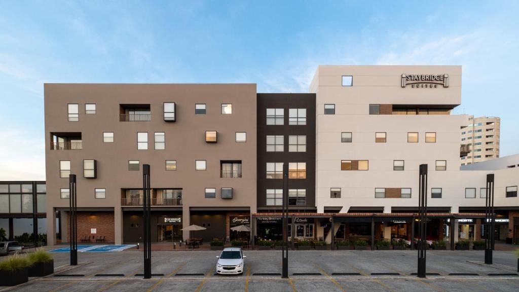 a car parked in a parking lot in front of a building at Staybridge Suites - Villahermosa Tabasco, an IHG Hotel in Villahermosa