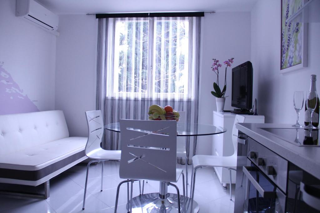 sala de estar blanca con mesa y ventana en Mladena Apartment, en Split