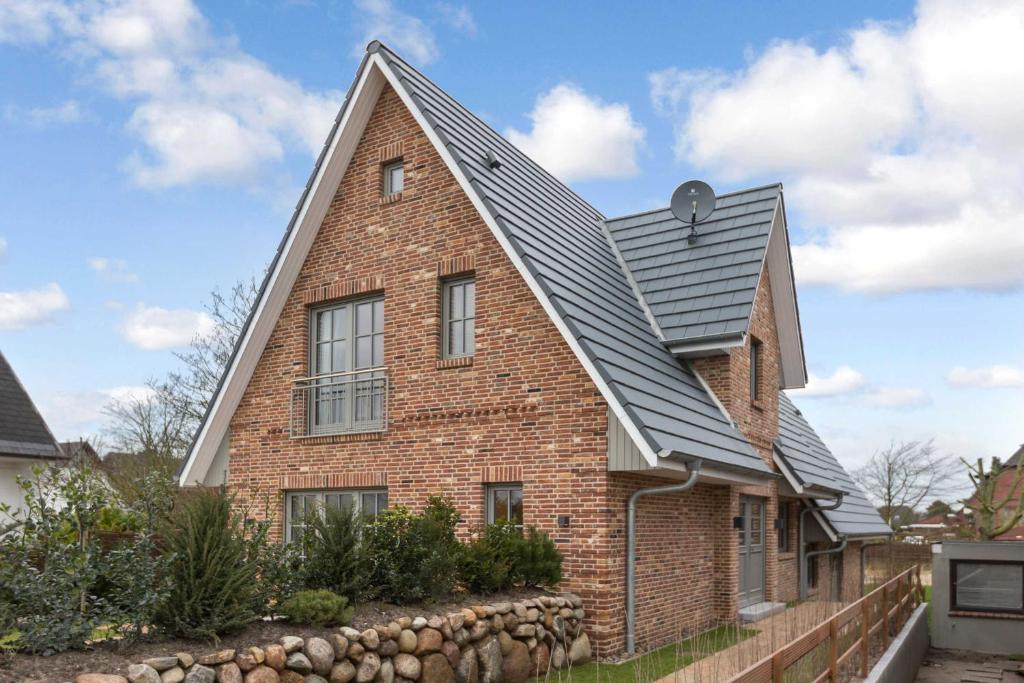 una casa de ladrillo con techo de gambrel en Deichstieg, en Westerland