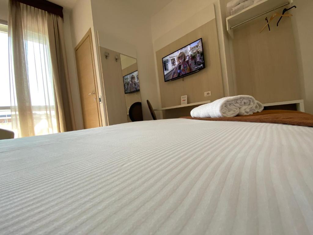 Postel nebo postele na pokoji v ubytování Hotel Ristorante Novara Expo