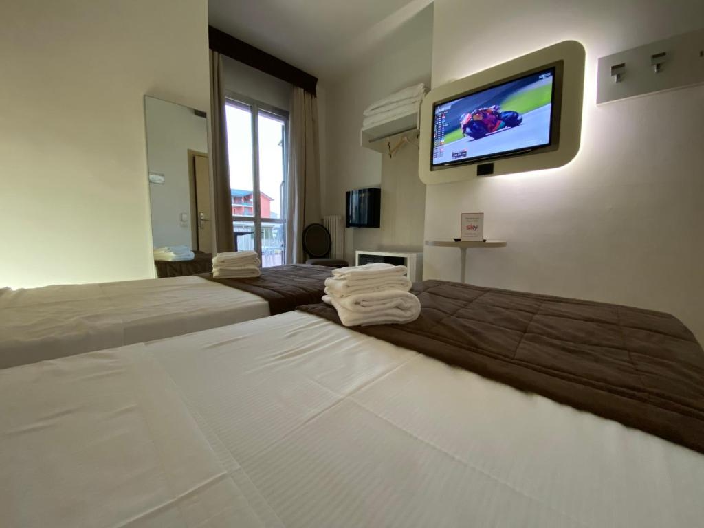 Postel nebo postele na pokoji v ubytování Hotel Ristorante Novara Expo