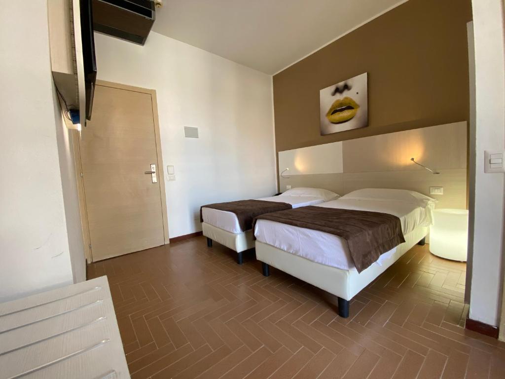 Postel nebo postele na pokoji v ubytování Hotel Ristorante Novara Expo