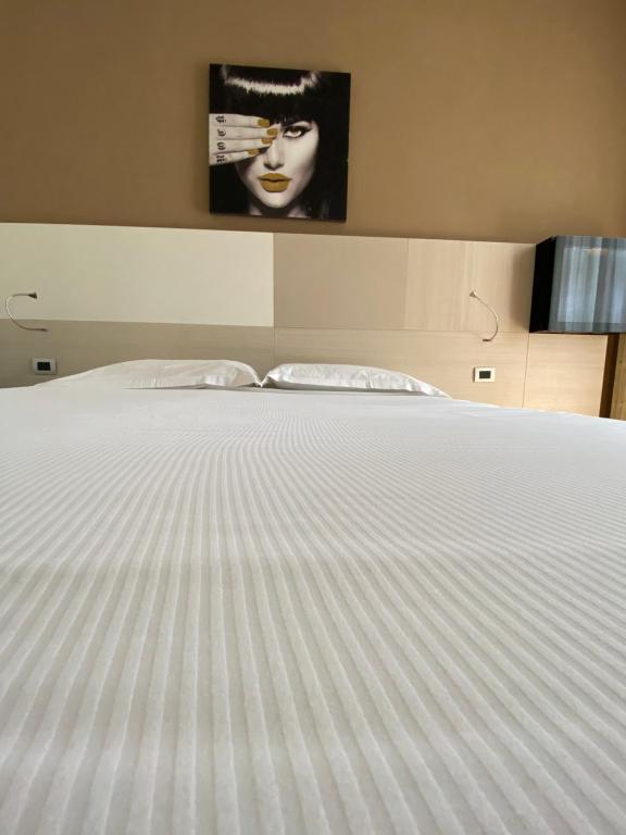 Postel nebo postele na pokoji v ubytování Hotel Ristorante Novara Expo