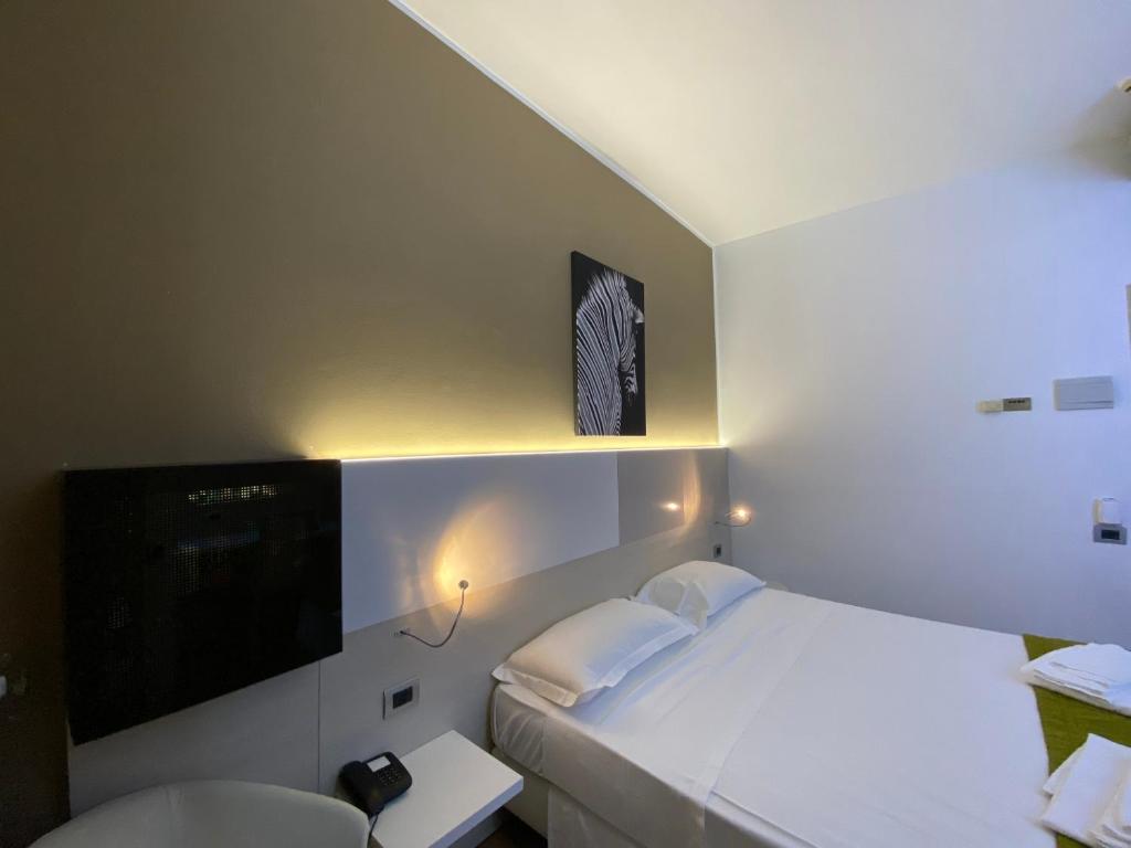 Postel nebo postele na pokoji v ubytování Hotel Ristorante Novara Expo