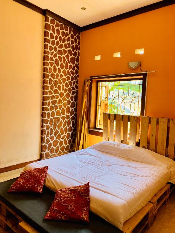 Postel nebo postele na pokoji v ubytování Hotel Santoso Batu