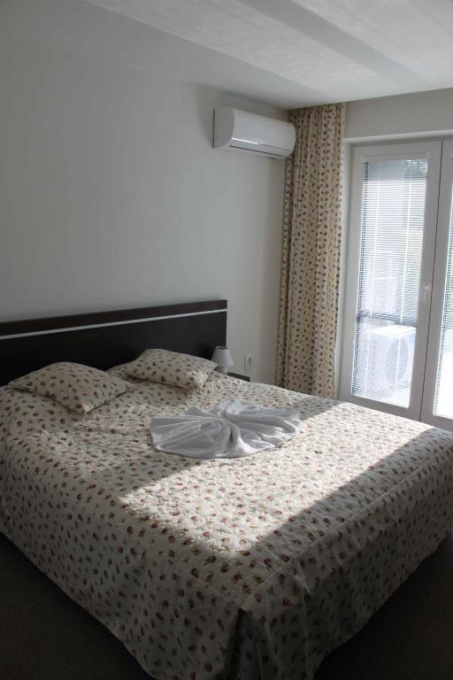 Postel nebo postele na pokoji v ubytování Apartmany Arcadia