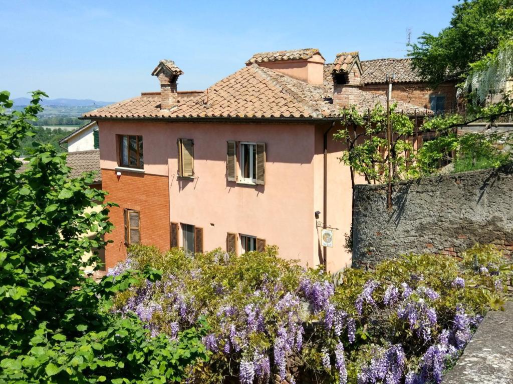 a house on a hill with purple flowers at Casa "Le tre Muse" in Deruta