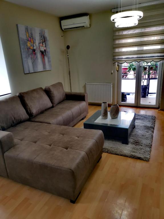 a living room with a couch and a coffee table at CITY RENT 7 Apartments in Jagodina