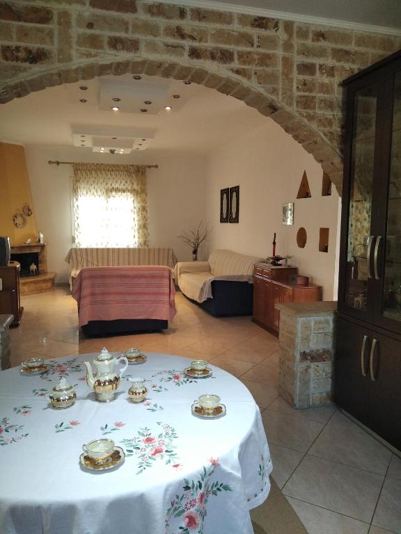 a living room with a table with dishes on it at Villa Erasmia in Dhékarkhon