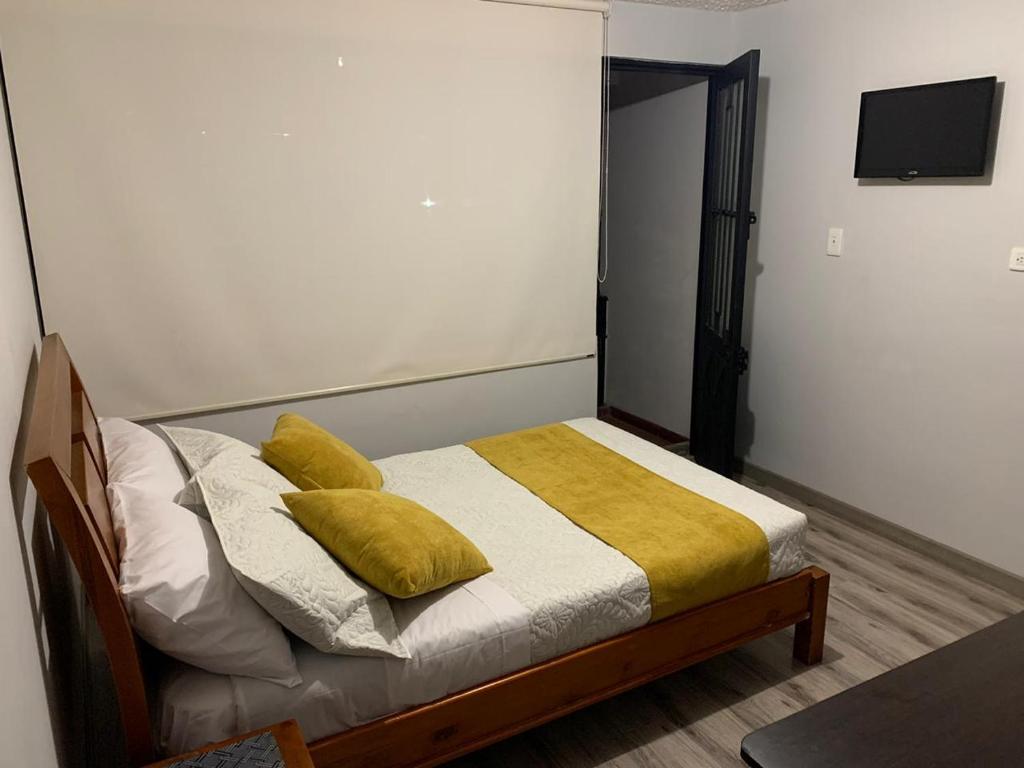 Voodi või voodid majutusasutuse Hospedaje Casa Bachué toas