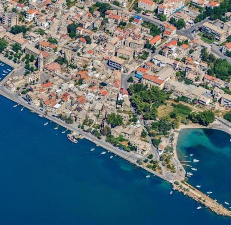 an aerial view of a harbor with boats in the water at apartments TONI with free parking in Ka&scaron;tela
