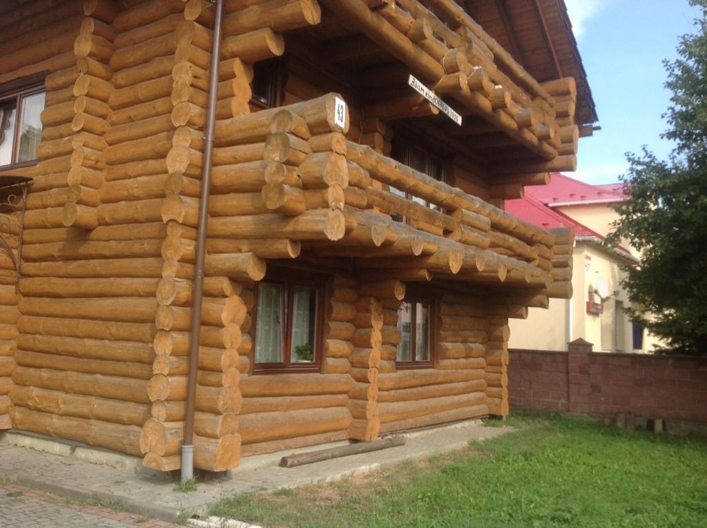 a log cabin with a wooden facade at Villa Carpathian Aura in Skhidnitsa