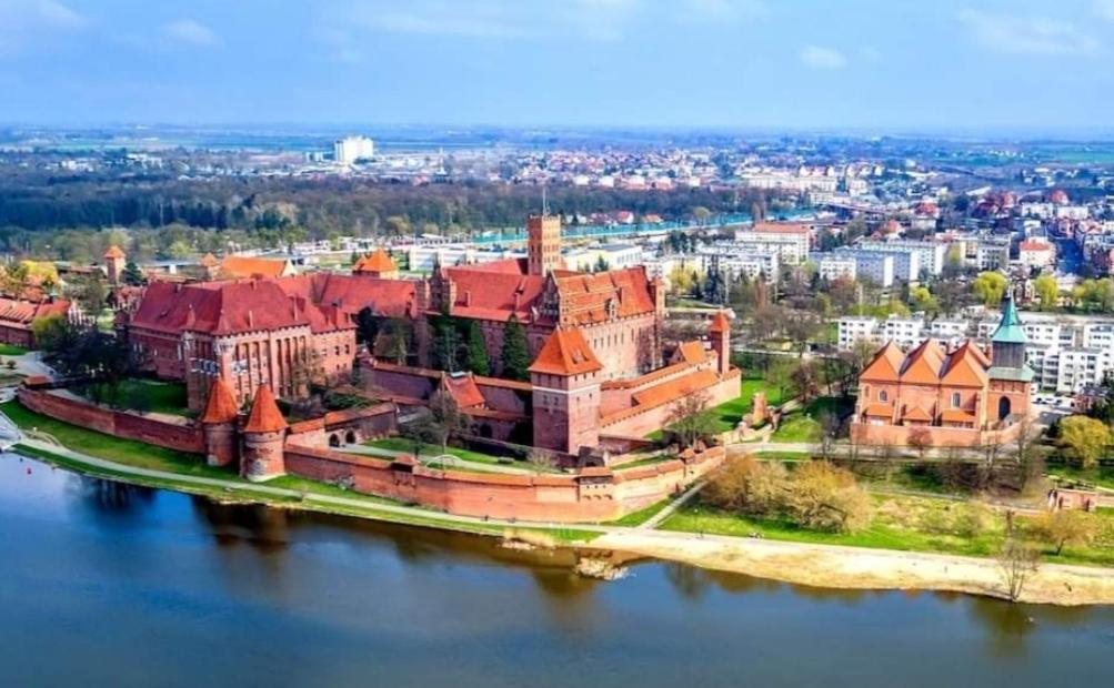 an aerial view of a castle on the water at Apartament Anielki in Malbork