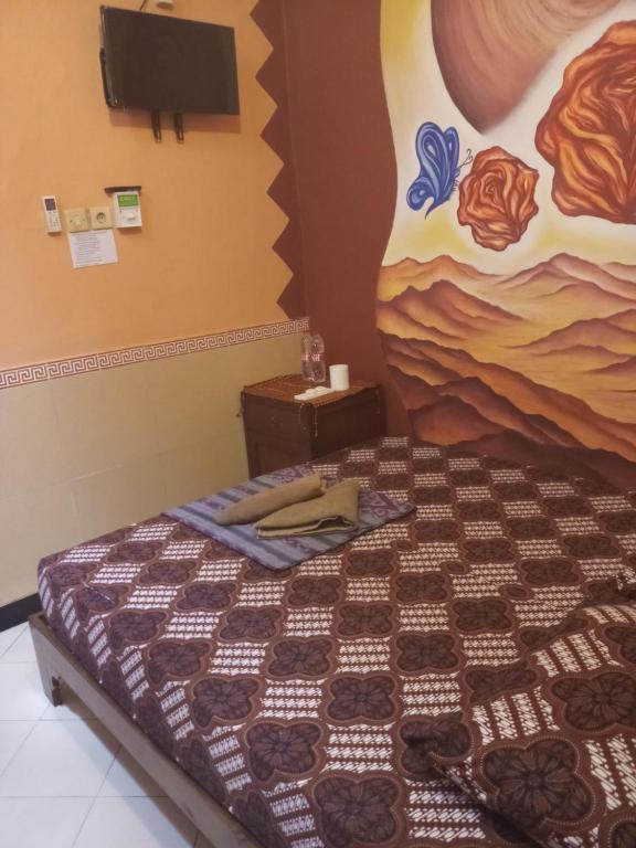 Postel nebo postele na pokoji v ubytování Losmen Setia Kawan