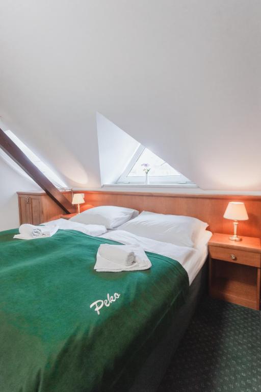 Postel nebo postele na pokoji v ubytování Hotel Peko