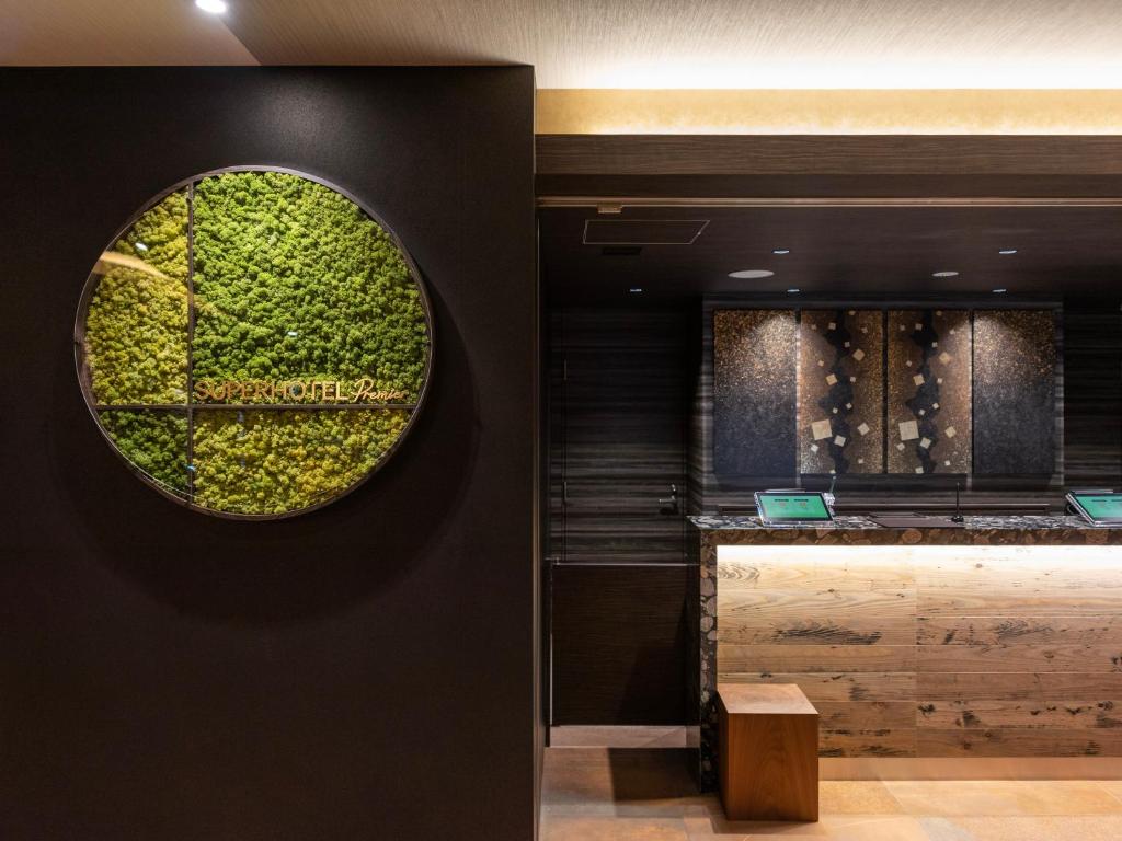 a restaurant with a green wall with a window at Super Hotel Premier Kanazawaeki Higashiguchi in Kanazawa