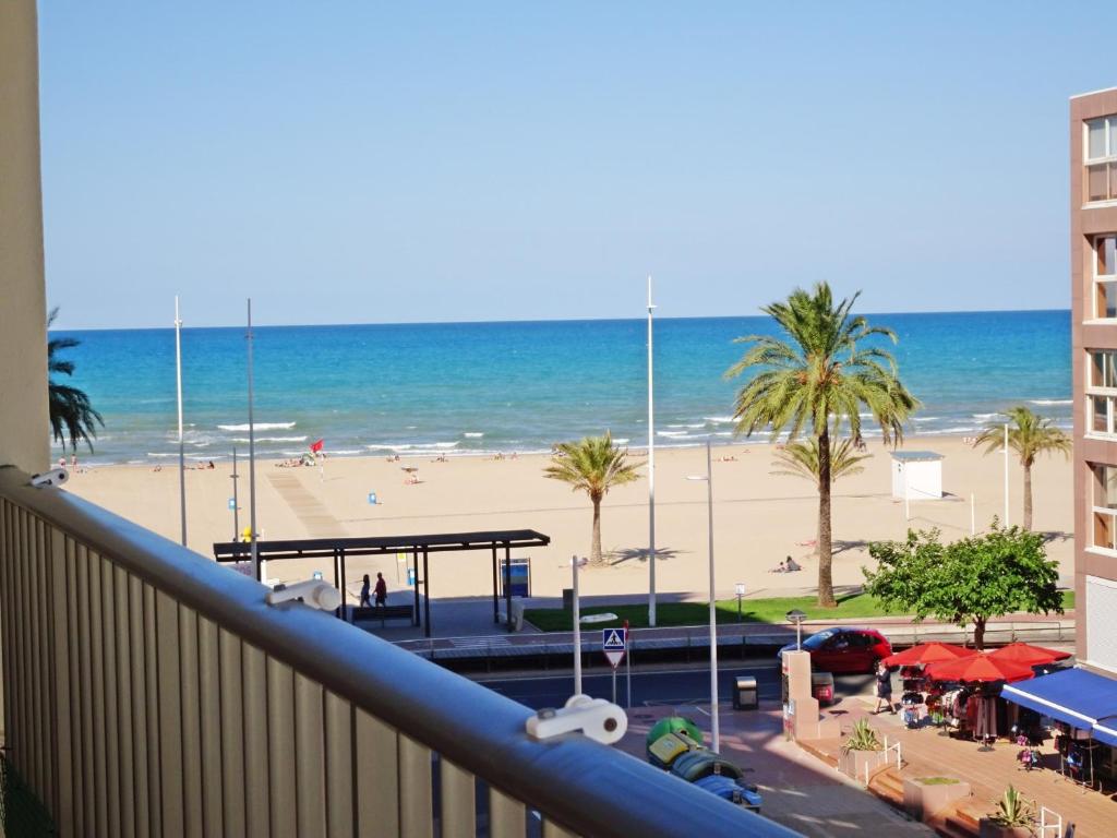 a view of a beach and the ocean from a balcony at Infante - Primera Línea de Playa in Playa de Gandia