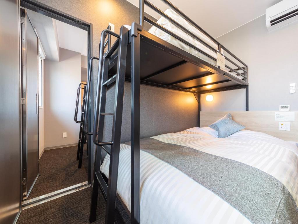 a bunk bed in a small room with a bunk beduteneway at Super Hotel Premier Kanazawaeki Higashiguchi in Kanazawa
