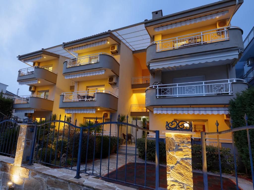 a building with a fence in front of it at Apartments Bellevue in Keramotí