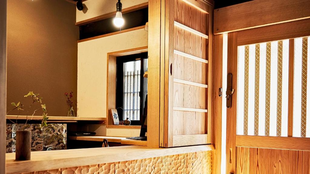 a wooden door in a room with a mirror at Kokonoe Machiya in Kyoto