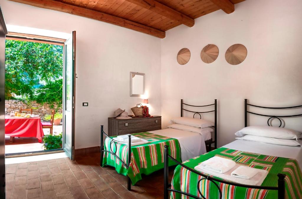 Postel nebo postele na pokoji v ubytování Agriturismo Borgo degli ulivi