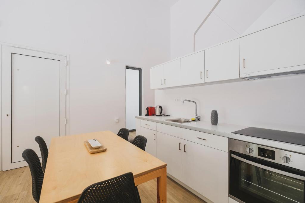 A kitchen or kitchenette at Sun-splashed Stylish Flat, steps to City Old Town