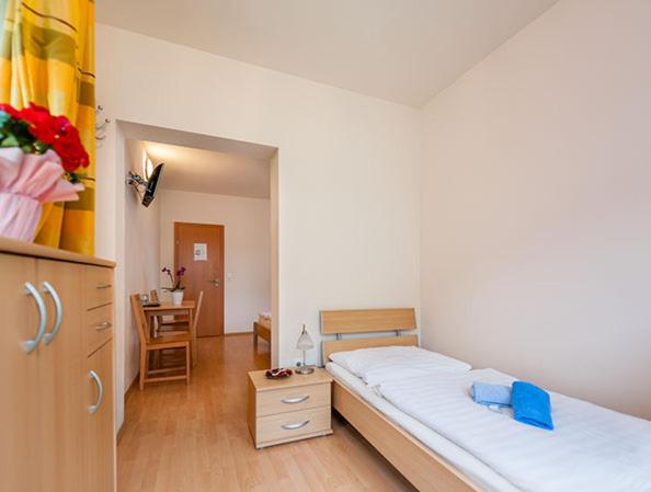 a bedroom with a large bed and a desk at Hotel Waitz -Self Check In in Unterwaltersdorf