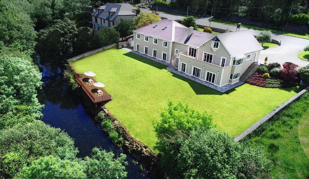 an aerial view of a house with a boat on a river at Ardilaun Guesthouse Self Catering in Ennis