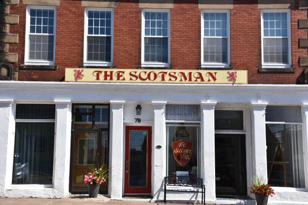 a store front with a chair and a window at The Scotsman Inn in Pictou