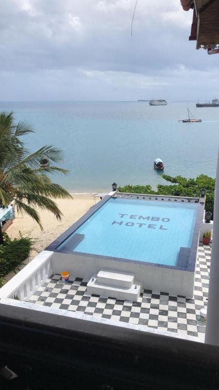 a swimming pool with a view of the ocean at Tembo House Hotel in Zanzibar City