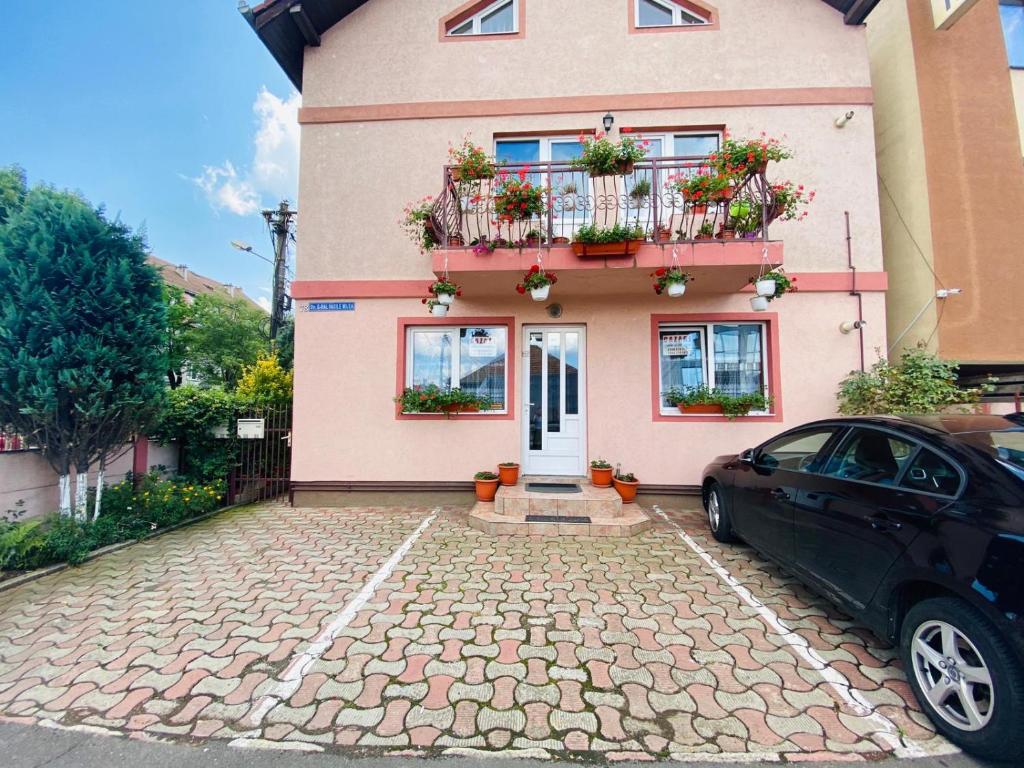 ein Haus mit einem davor geparkt in der Unterkunft Amazing House Cazare in Sibiu