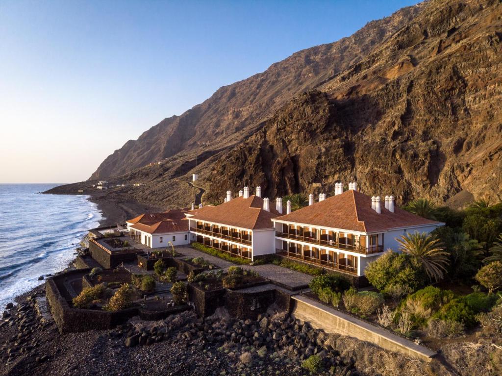 an aerial view of a house on the side of a cliff at Parador de El Hierro in Las Casas