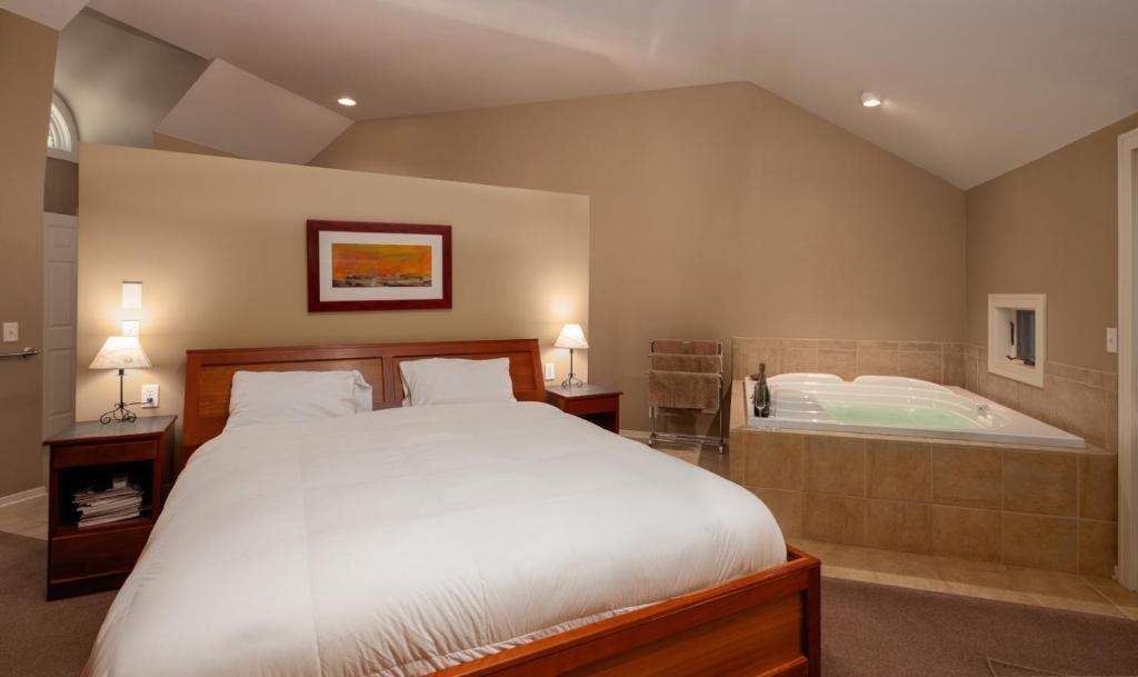 A bed or beds in a room at Pigeon Creek Inn - Adults Only